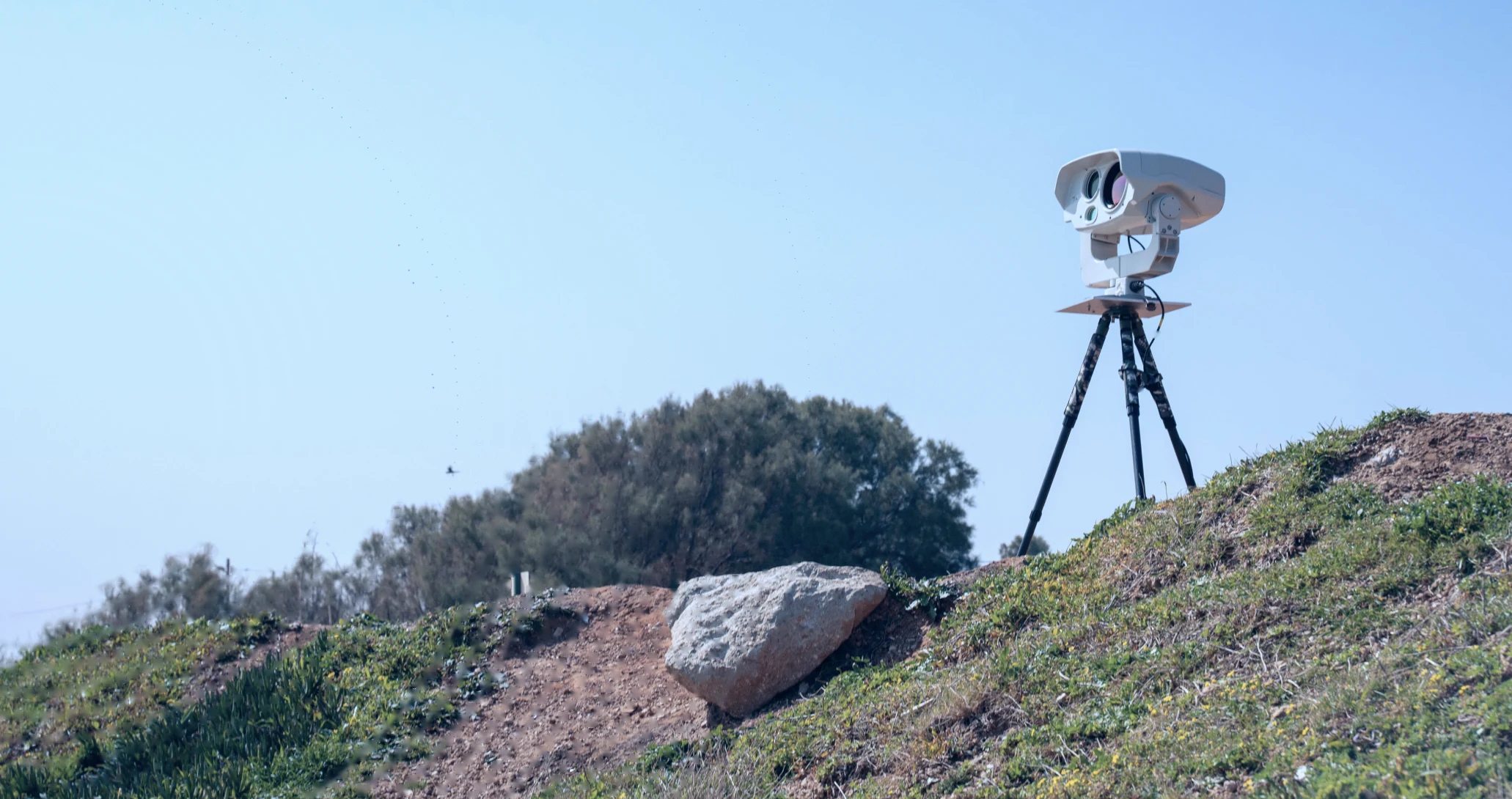 BeeSense surveillance system on a tripod overlooking open ground