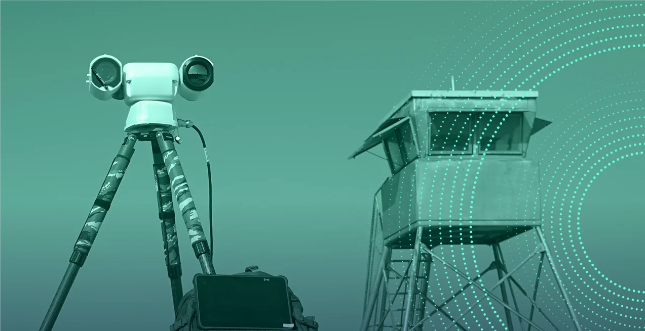 BEE surveillance system on a tripod beside a guard tower