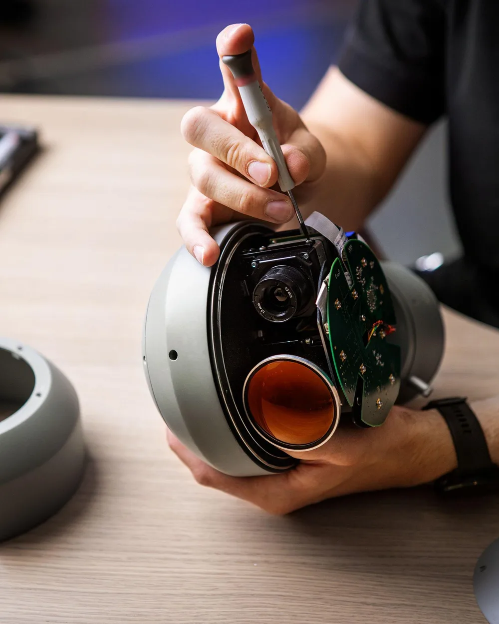 Engineer assembling the sensor head of a DST gimbal