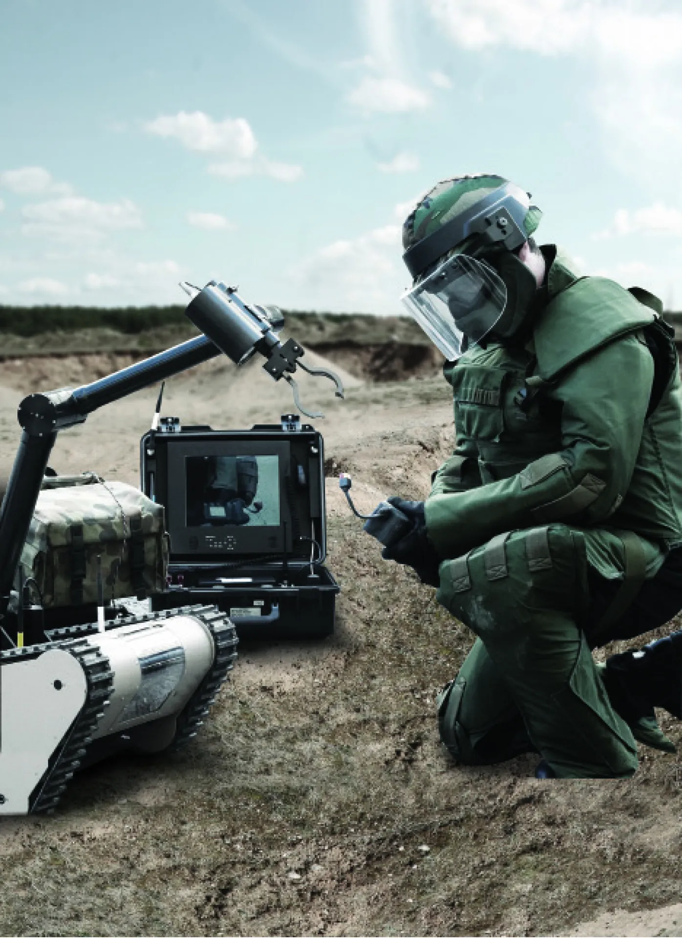 EOD operator in a bomb suit controlling a robot